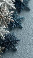 Decorative glittery snowflakes arranged on textured blue background create a winter ambiance for holiday celebrations photo