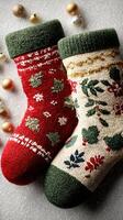 Christmas stockings decorated with festive designs on a textured surface surrounded by ornaments photo