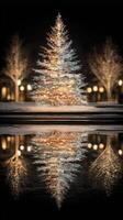 Beautifully illuminated Christmas tree reflecting in water at night in a festive city square during the holiday season photo