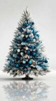 Decorated Christmas tree with blue and silver ornaments showcasing festive spirit in a bright indoor setting photo