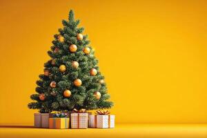 Festive Christmas tree adorned with golden ornaments and surrounded by colorful gifts against a vibrant yellow background photo
