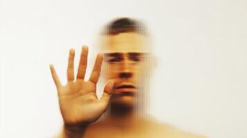 Abstract portrait of a man behind fluted glass, expressing depression, confusion, and isolation. Conceptual image of emotional struggle, mental health, and psychological pressure. photo
