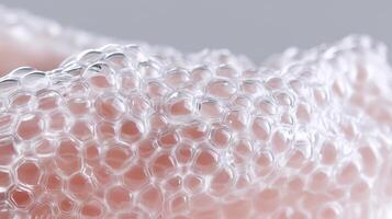 Macro view of transparent synthetic skin material with honeycomb texture, representing innovative biomedical engineering and advanced tissue design for human transplantation and wound healing. photo