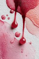 A red liquid dripping down a white surface photo