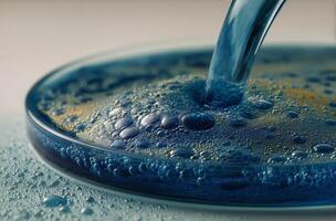 A blue liquid being poured into a bowl photo