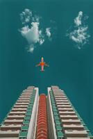 A plane flying over a tall building with a red stripe photo