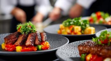 A group of chefs preparing food on plates photo