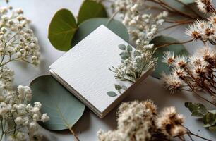 A white square with flowers and leaves on it photo