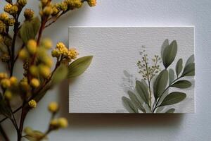 A small square of white paper with a small plant photo