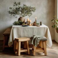 A table with a white tablecloth and wooden stools photo