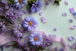 Purple flowers and ribbon on a green background photo