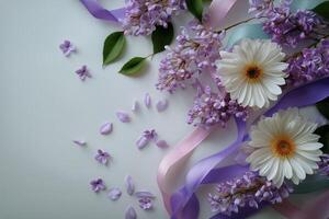 Purple flowers and ribbon on a white surface photo