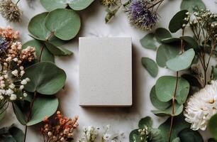 A white square of soap surrounded by flowers photo