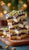 A stack of chocolate star cookies with pistachios photo