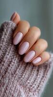 A woman's hand with pink nails and a pink manicure photo