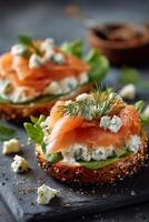 Smoked salmon sandwich with cream cheese and dill on a dark slate photo