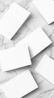 White Blank Business Cards Scattered on a Marbled Surface with Soft Lighting photo