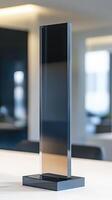Sleek Black Glass Structure Standing On White Table In Minimalist Design photo