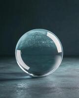 Transparent Glass Sphere Reflecting Dark Textured Surface with Soft Lighting photo