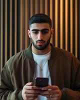 Young Man Using Smartphone Indoors Modern Interior Design Background photo