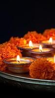 Lighted Candles Resting In Ornate Bowl With Marigolds photo