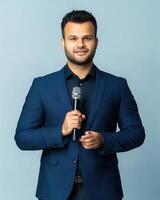 Confident Speaker Holding a Microphone, Portrait of a Man in a Blue Suit, Professional Presenter Ready to Speak photo