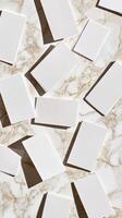 Scattered White Cards on Marble Surface Casting Shadows Creating Geometric Pattern for Abstract Background photo
