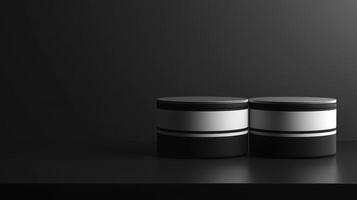 Two Black and White Cylindrical Objects on a Dark Reflective Surface with Dramatic Lighting photo