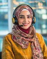 Portrait of a Smiling Muslim Woman Wearing a Headset in a Modern Office Setting photo