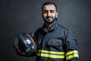 Portrait of a Smiling Firefighter Holding His Helmet Against a Dark Background A Brave and Dedicated First Responder photo