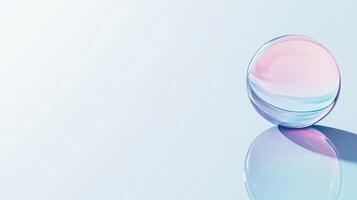 Translucent Sphere Reflecting Pink And Blue Gradient Resting On Reflective Surface photo