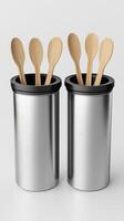 Two Metal Utensil Holders With Wooden Spoons on White Background photo