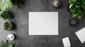 Workspace Overhead View With Blank Paper Surrounded By Plants And Office Accessories On Dark Textured Surface With Natural Light photo