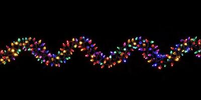 Multicolored Christmas Lights on Black Background. photo