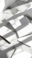 White Square Towels on Marble Surface with Harsh Shadows and Sunlight photo