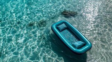 Teal Inflatable Raft Floating on Calm Turquoise Water photo