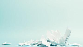 Shredded paper scattered on a light blue surface photo