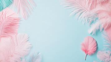 Soft pastel feathers arranged on a blue background photo