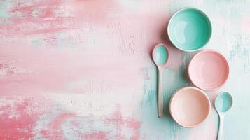 Bowls and spoons arranged on a pastel background photo