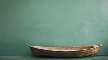 Wooden boat resting against a green wall indoors photo