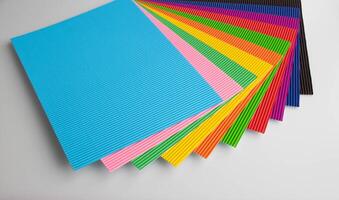 A stack of colorful sheets of corrugated paper for classes with children photo
