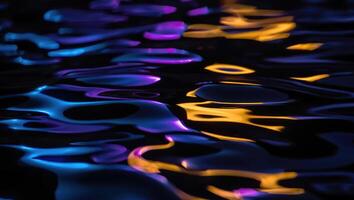 Vibrant reflections in water create a colorful abstract pattern during nighttime hours by a calm lakeside photo