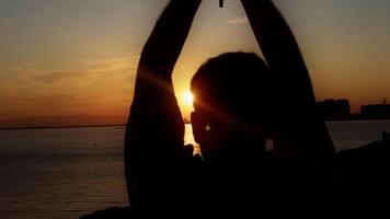 Young Man Silhouette Hand is Holding Christianity Religion Symbol Cross in Sunset Light video