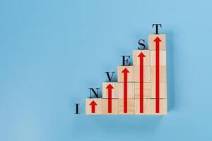 Conceptual image of the word invest formed by wooden blocks stacked symbolizing photo