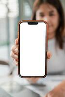 Close-up of a woman displaying a smartphone with a blank screen, ideal for app or website mockups. photo