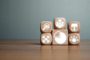 Wooden blocks with icons representing market segmentation, ideal for business strategy and target audience visuals. photo