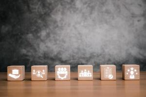 Wooden blocks symbolize assessment center concepts like teamwork, evaluation, and business strategy on a textured background. photo