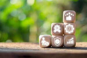 Wooden blocks with performance icons symbolizing new standards in productivity and efficiency in a natural setting. photo