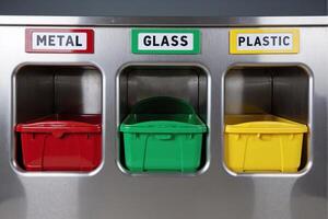 Modern Metal, Glass and Plastic Color-Coded Recycling Bins with Red, Green and Yellow Containers in Stainless Steel Frame, Environmental Waste Sorting System with Clear Labeled Compartments photo