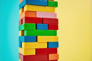 A stack of colorful blocks on a blue background photo